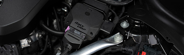 RaceChip RS control unit installed in an engine bay with the OEM connector plugged in.